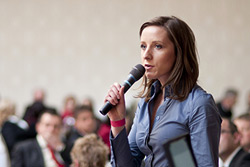 Woman speaking at public meeting