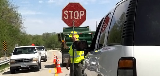 Flagger holding stop sign