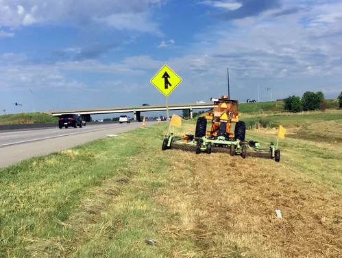 Tractor mowing grass in an interstate right of way