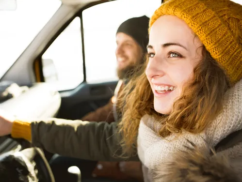 Woman driving in winter with stocking hat on 