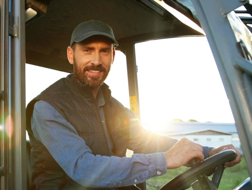 Farmer driving tractor