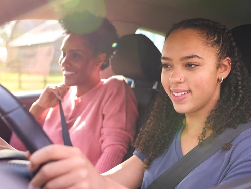 Young driver driving with adult