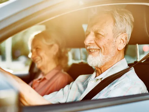 Older couple driving in a car