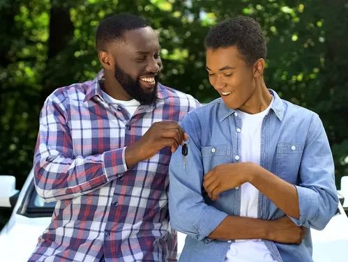 Dad giving teen driver car keys