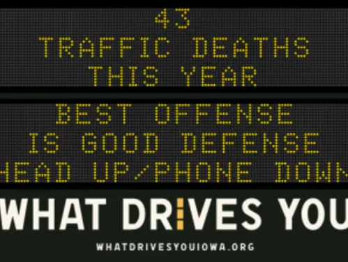 Traffic roadside graphic with text of the news article title.