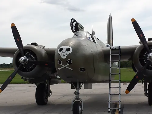 A black historic Warbirds airplane owned by Greg Gobble, with a white skull and crossbones painted on the nose