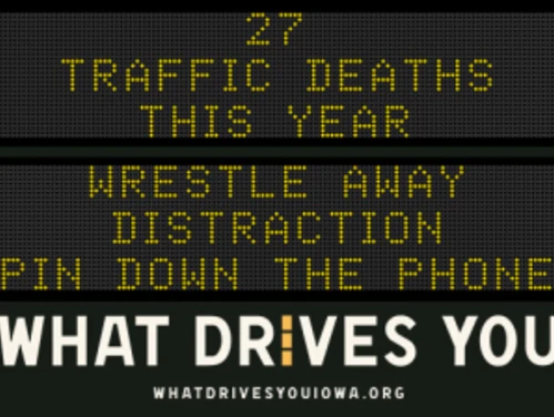 Traffic roadside graphic with text of the news article title.