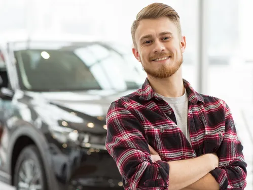 Man standing in front of a car