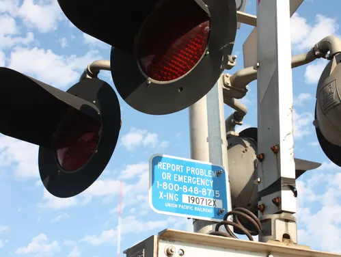 Blue sign posted at rail crossing