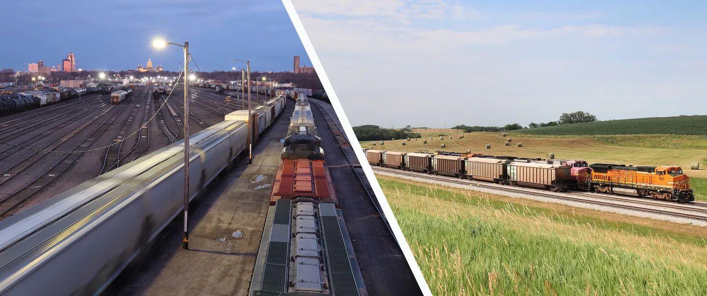 Multiple tracks in a rail yard.  Two trains operating on a double rail main line