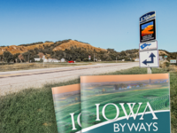 Byway road with sign and images of the current Byways Guide in the foreground