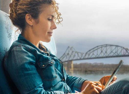 Woman viewing the Lansing Bridge Water Taxi information on her phone