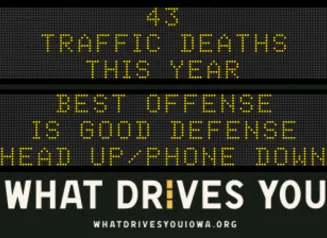 Traffic roadside graphic with text of the news article title.