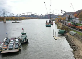 Mississippi River Bridge with car ferry in foreground