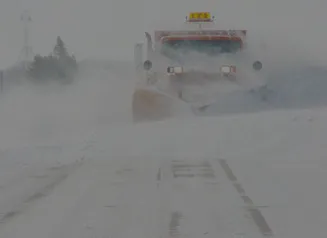 DOT snowplow clearing in whiteout conditions