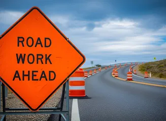 Photo of Road Work Ahead sign on construction site