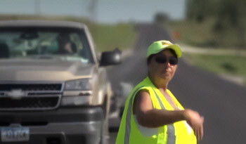 Flagger waving traffic through