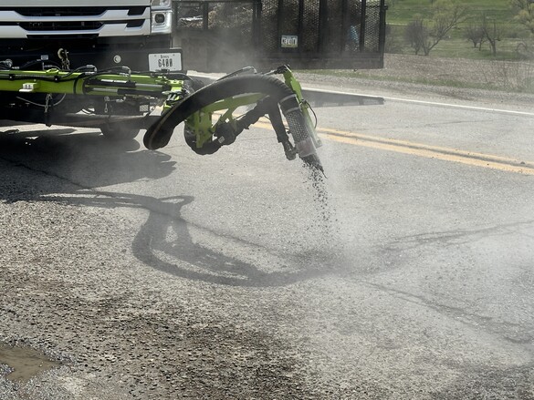 Iowa DOT Durapatcher nozzle spraying emulsion