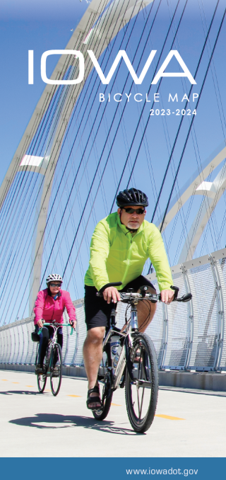 two people riding bikes on a bridge