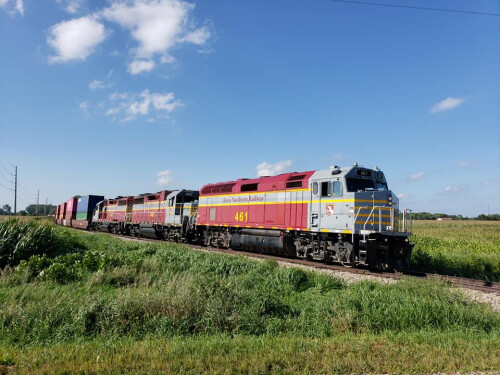 A train on tracks in a grassy area