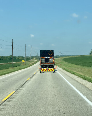 Construction truck with warning lights to signal drivers of upcoming construction.