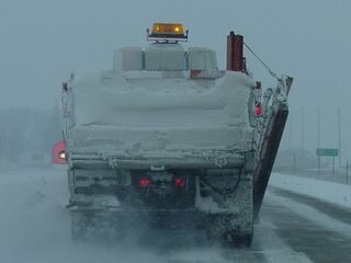 Snow covered back side of a plow truck