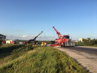 Crew helping to clean up a crash scene on a highway