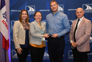 Four people standing together at an awards ceremony