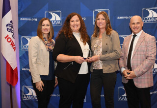 Four people standing together at an awards ceremony