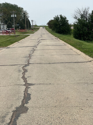 repaired crack running down the length of a section of an old highway