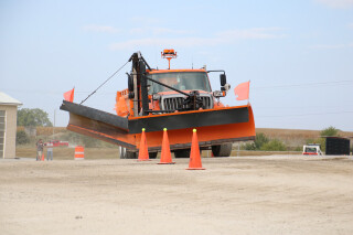 An orange snowplow competing in the "roadeo"