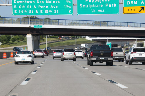 a highway with alternating black and white lane dashes
