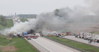 drone shot of a smoke-filled traffic incident on a divided highway in Iowa