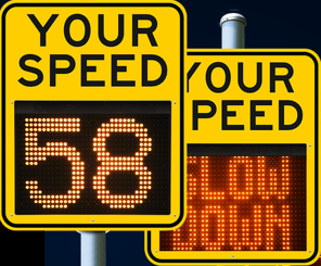 two speed alert signs, one reads "Your Speed: 58," and one reads "Your Speed: Slow Down"