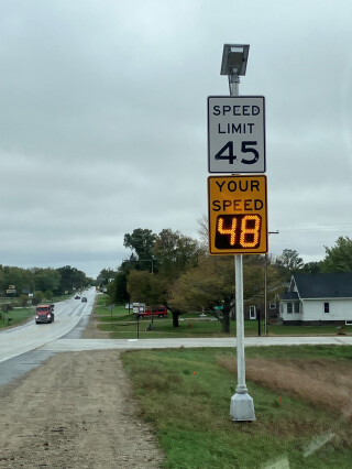 a speed feedback sign posted alongside a road