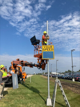 DOT crew installing a speed feedback sign