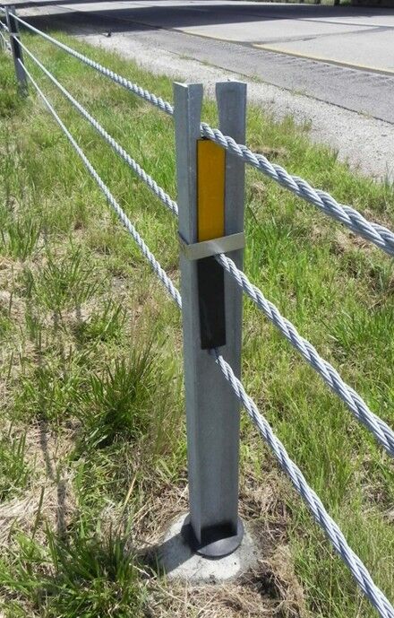 High‑tension cable guardrail post with cables attached.