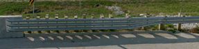 BTS guardrail transition with Thrie‑beam rail connecting to a bridge rail.