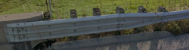 STS guardrail transition with Thrie‑beam rail leading into a bridge rail.