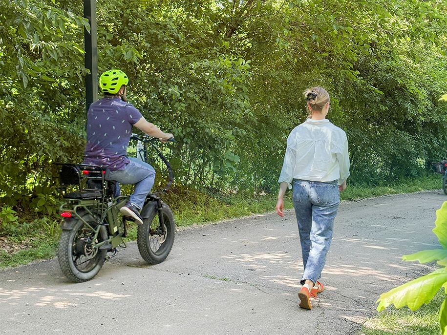 E-Bikes sharing trail with a walker